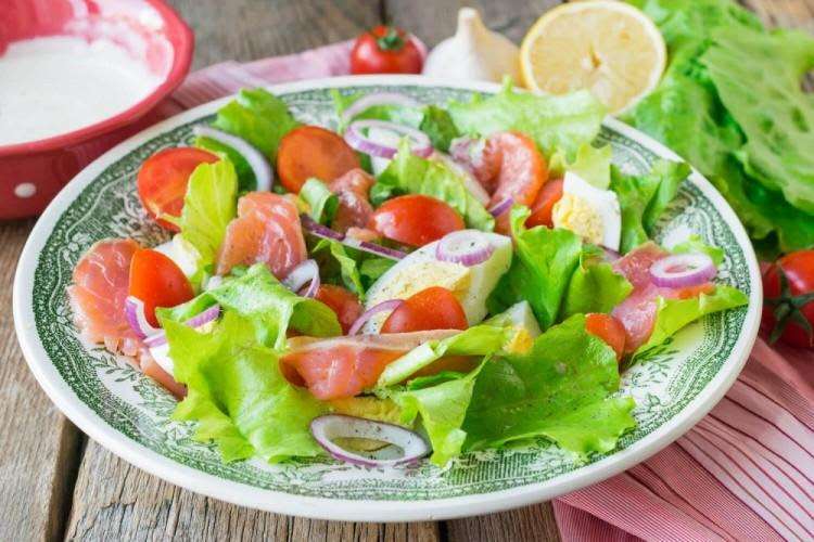 Salad with red fish and cedar nut flakes